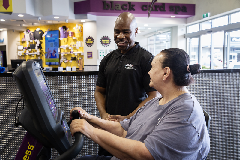 A staff member with an Indigenous client working on Heart Rehab