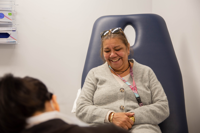 A podiatrist with an Indigenous client