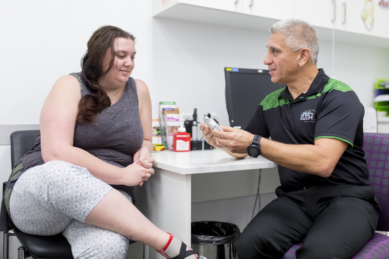 A pharmacist and a client discussing pharmacy information for Mob.